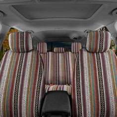 the interior of a car with multicolored seat covers