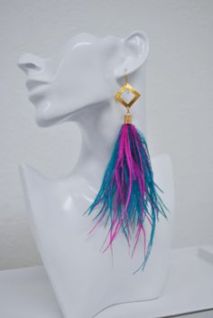 a white mannequin head with a pair of colorful earrings on top of it