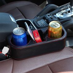 an organized car cup holder holds cans and other personal items in the backseat of a car