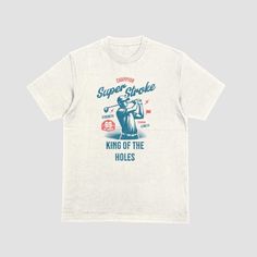 how off your love for golf with our stylish t-shirt featuring the bold and playful phrase "Super Stroke King of the Holes." This tee is perfect for golfers who enjoy adding a bit of humor to their game, making it an ideal addition to your casual wardrobe. Crafted from our premium bi-blend fabric, this t-shirt offers a comfortable and durable fit, perfect for a day on the course or a casual outing with friends. Whether you're hitting the green or just want to showcase your golf pride, this tee is sure to be a hole-in-one! Available only in adult sizes for $25, this shirt is a must-have for any golf enthusiast looking to add some fun to their game. Wear it with pride and claim your title as the "King of the Holes." Graphic Tee Crew Neck T-shirt For Golf, Cotton T-shirt With Letter Print For Golf, Golf T-shirt With Letter Print And Crew Neck, Golf Graphic Print Crew Neck T-shirt, Crew Neck T-shirt With Graphic Print For Golf, Graphic Print Crew Neck T-shirt For Golf, Golf T-shirt With Graphic Print And Short Sleeves, Graphic Cotton T-shirt For Golf, Cotton Graphic Tee For Golf