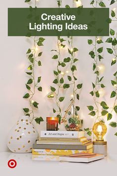 some books are sitting on top of each other with plants growing over them and the text creative lighting ideas