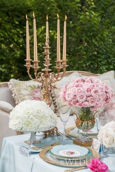 a table with flowers and candles on it