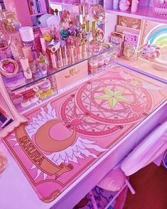 a pink desk topped with lots of items