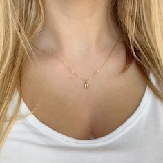 Elevate your style and showcase your astrological sign with our Gemini Zodiac Symbol 14K Gold Necklace. Handcrafted with a 14K gold filled chain and a 18k vermeil gold charm, this minimalist yet meaningful necklace is the perfect addition to your jewelry collection. Available in 16 or 18 inch necklace sizes. Celebrate yourself or a loved one with fine jewelry that shines as bright as your special day! 14k gold chain 14k lobster clasp 18k vermeil gold charm 16 & 18 necklace sizes makes a great gi Dainty Zodiac Sign Necklace For Gift, Minimalist Gold Zodiac Sign Necklace, Gold Minimalist Zodiac Charm Necklace, Dainty Zodiac Sign Pendant Necklace, Gold Dainty Zodiac Sign Charm Necklace, Gemini Zodiac Symbol, Gemini Necklace, Gemini Pendant, Meaningful Necklace