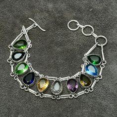 Beautiful Made By love Multi Gemstone Bracelet 925 Sterling Silver Bracelet Handmade Jewelry, Made By the most Experienced Silver Artisans. Artisans those are making jewelry from last 20-25 years . Gift for Her Gift for mom  Bracelet Details Mentioned below -  Gemstone- Multi Gemstone ( Lab Created) Bracelet Length- 8 Inch 925 Stamped - Yes Metal- 925 Sterling Silver Purity- 925 Parts Per 1000 Our Goal is 100% Customer Satisfaction This piece of jewellery is designed and handmade by me. Any question , please do not hesitate to contact me. All the Jewelry pieces will be sent inside a gift box and a bubble envelope. I'm adding everyday new designs to my store -  kaviarty.etsy.com Please mark as Favorite so that You can see the item in your favorite list or You can add in basket :) Feel Free Sterling Silver Bracelets Handmade, Multi Gemstone Bracelet, Mom Bracelet, Topaz Bracelet, Moms Bracelet, Handmade Jewelry Gift, Sapphire Bracelet, Bracelet Handmade, Sterling Silver Bracelet