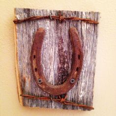 an old horseshoe hanging on a wooden wall