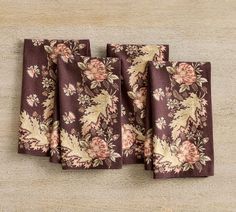 three napkins with floral designs on them