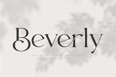 the word beverly written in black and white on a gray background with leaves