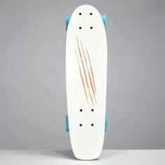 a white skateboard sitting on top of a gray table next to a blue handle