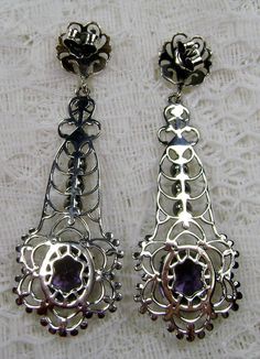 Simulated Purple Amethyst Solid Sterling Silver Earrings Lavaliere Design#E17 Inspired by Victorian era designs, I now offer these lovely Antique estate reproduction earrings in sterling silver (recast from an Antique lavaliere pendant). Each stunning 4 carat flawless Man-made/simulated purple amethyst is 11mm long (just under 1/2") and 9mm in width (3/8"). The lovely amethyst have an excellent light purple color. The earrings are just over 2" inches in length. These earrings are ethereal and cl Ornate Purple Jewelry With Matching Earrings, Ornate Purple Dangle Earrings, Ornate Purple Drop Earrings, Purple Earrings With Intricate Design As Gift, Purple Earrings With Intricate Design For Gift, Ornate Purple Dangle Jewelry, Ornate Purple Pierced Earrings, Purple Pierced Earrings For Wedding, Ornate Metal Earrings For Formal Occasions