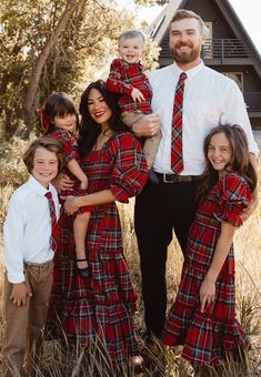 a man and two children are posing for a family photo