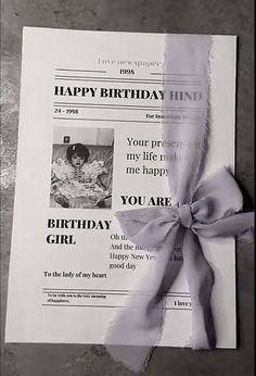 a piece of paper with a ribbon tied around it that says happy birthday, you are girl