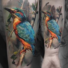 colorful bird tattoo on both legs