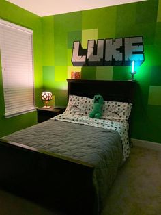 a bed room with a neatly made bed next to a window and a green wall