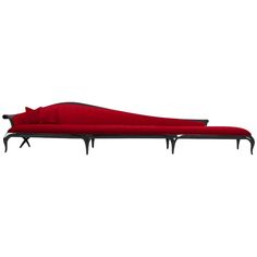 a red couch sitting on top of a metal frame