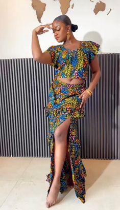 The AYANA African Print Maxi Floral Skirt And Top is just a fun outfit that will take you from day to night. A beautiful multi colored floral print skirt and crop top that deserves space in your chic wardrobe. Look Unique. Know You Are Beautiful. Available in sizes S-2XL Blue, Green, Orange, Yellow, Pink, And Black In Color Crop Top Floral Print  Ruffled Tiered Skirt   CARE Hand Wash Or Machine Wash On Cool Gentle Cycle. Line Dry, Steam Iron. Long Skirt And Blouse, Skirt And Blouse Ankara, Maxi Floral Skirt, Maxi Skirt And Top, Skirt African Print, African Print Maxi Skirt, Printed Long Skirt, Chic Wardrobe, Floral Print Crop Top