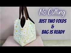 a white bag with yellow flowers on it and the words, no cutting just two folds & bag is ready