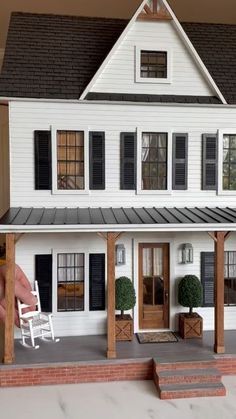 a doll house is shown with the porch and steps leading up to the front door