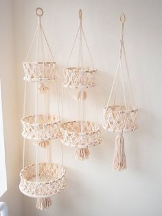 three macrame baskets hanging on the wall