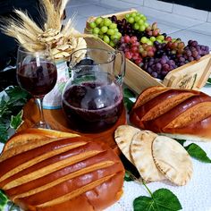 bread, grapes and wine on a table