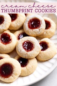 there are small cookies with jelly on them and the words, cream cheese thumbprint cookies