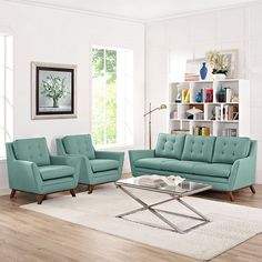 a living room with two couches and a coffee table in front of a bookcase