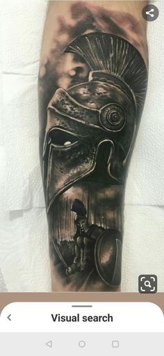 a man's leg with a spartan tattoo on it