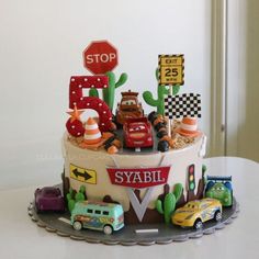 a birthday cake with cars and street signs on it