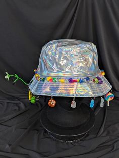 -hat color - silver -bead color - rainbow -charm color - rainbow -unisex adult size -inner circumference - 22.5in -crown dip - 3in -brim - 2.25in -NOT machine washable -Perfect for raves and outdoor festivals! Shipping within the US USPS First Class Package 3-9 days USPS Priority Mail 1-5 days USPS Priority Mail Express 1-3 days Shipping International  USPS First Class Mail International  -Varies- USPS Priority Mail International 6-14 days USPS Priority Mail Express International 3-9 days Shipping times are estimated, NOT GUARENTEED.  +International buyers are responsible for all import fees+ +Orders of $50+ may require signature confirmation upon delivery+ Fun Adjustable Hat For Carnival, Adjustable Silver Costume Hats And Headpieces For Festival, Novelty Multicolor Adjustable Costume Hat, Adjustable Rainbow Hat For Festivals, Adjustable Multicolor Novelty Costume Hats And Headpieces, Adjustable Rave Hats For Festivals, Bohemian Silver Hat For Festivals, Silver Bohemian Hat For Festival, Adjustable Multicolor Novelty Hat