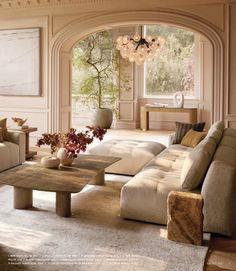 a living room filled with furniture and a chandelier