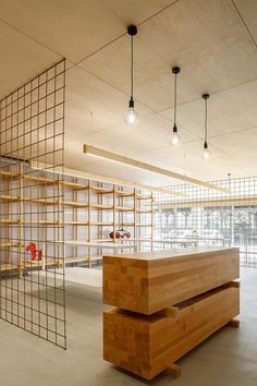 an empty room with shelving and shelves in the center, surrounded by metal grids