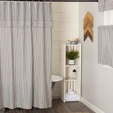 a bathroom with a shower curtain, toilet and bathtub in the middle of it