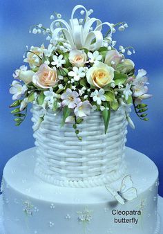 there is a white cake with flowers in it