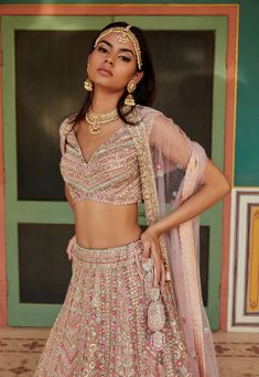 Explore lehengas, saris and jackets in romantic tones like sea blue, dusty rose and ash with intricate zardozi work, metallic bead work, French knots and multi-colored thread work. A collection of soft pastels for the bride, that encompases all her wedding dreams coming true. Embroidered Flowers