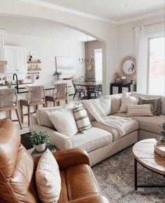 a living room filled with furniture and lots of windows