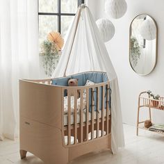 a baby crib in the corner of a room with white walls and flooring