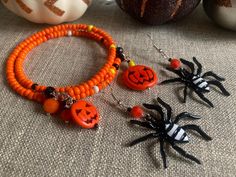 two halloween bracelets with orange beads and black jack - o'- lantern charms