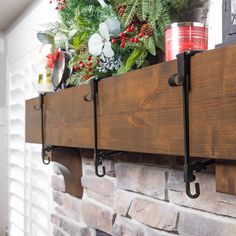 a fireplace mantle with christmas decorations and candles on it