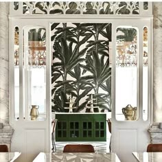 the dining room is decorated with tropical wallpaper