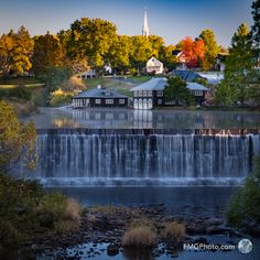 a view of a waterfall with houses in the background