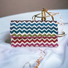 Colorful Rainbow Chevron Zig-Zag Beaded Clutch Crossbody Chain Bag Handbag * Beaded Front Bag * Bag Size: 9" L X 6" W * Chain Strap: Detachable 48" * One Inside Slip Pocket * Plain Woven Cotton Back * Reinforced Magnetic Snap Closure ➤Gift Wrap & Card Option Available At Checkout Multicolor Rectangular Evening Bag, Multicolor Rectangular Evening Bag For Festive Occasions, Multicolor Beaded Pouch Evening Bag, Multicolor Beaded Rectangular Evening Bag, Handmade Multicolor Rectangular Evening Bag, Multicolor Evening Bags With Handwork, Evening Multicolor Bags With Handwork, Festive Multicolor Beaded Bag, Multicolor Handwork Evening Bags