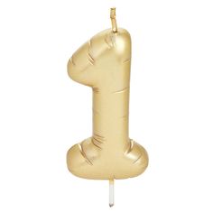 a gold candle shaped like the number one