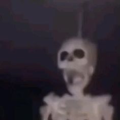 an animated image of a skeleton holding something in its hands and looking at the camera