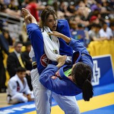 two people in blue and white uniforms doing karate