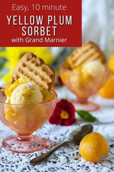 a bowl filled with ice cream next to two oranges on a lace tablecloth