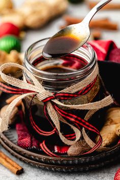 a spoon is in a jar filled with cinnamon sugar and christmas decorations on the table