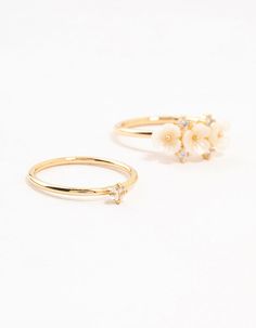 Add glamour with this 3-pack of gold-tone stacking rings. Featuring delicate floral designs, they're perfect for stacking or wearing solo. These rings add a chic, high-fashion touch to any outfit and sprinkle sparkle into your day. Material: Gold Plated Dimensions: Diameter 17 mm x Band Width 1 mm Feature Dimensions: Feature Width 17 mm x Feature Length 5 mm | Lovisa Gold Plated Triple Flower Stacking Rings 3-Pack Stacking Rings, Floral Designs, High Fashion, Gold Tones, Floral Design, Gold Plate, Plating, Sparkle, Band