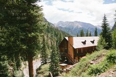 a cabin nestled in the mountains surrounded by trees