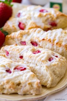 strawberry scones on a plate with lemons and strawberries