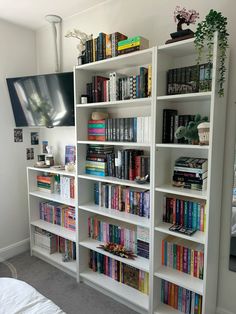 a white book shelf filled with lots of books